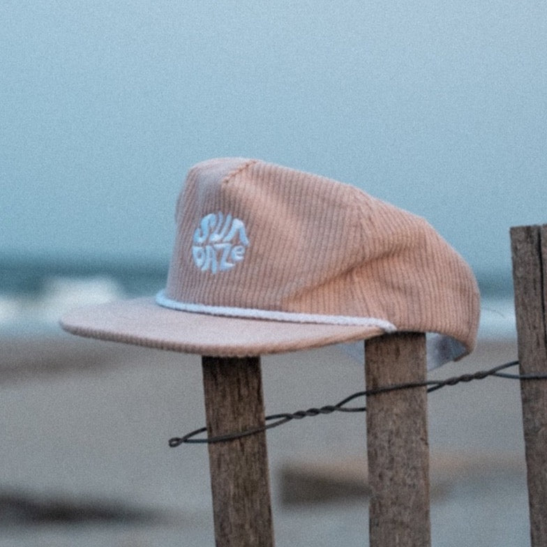 Tan Corduroy Unstructured, low crown, corduroy, embroidered design, adjustable strap, 5-panel hat with a surf hat style, flat brim, and five-panel hat design.