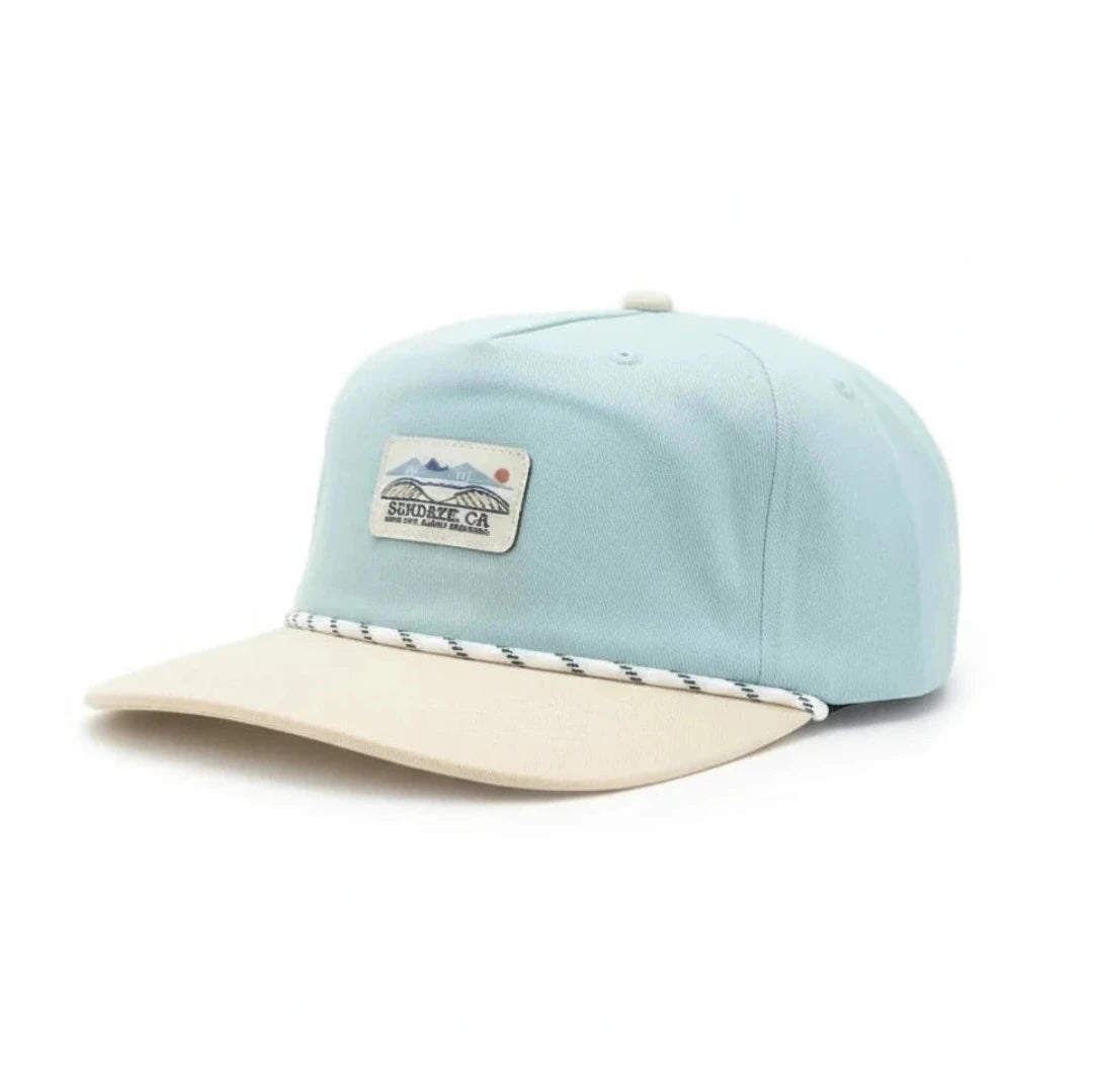 Light blue cap with beige visor on a white background