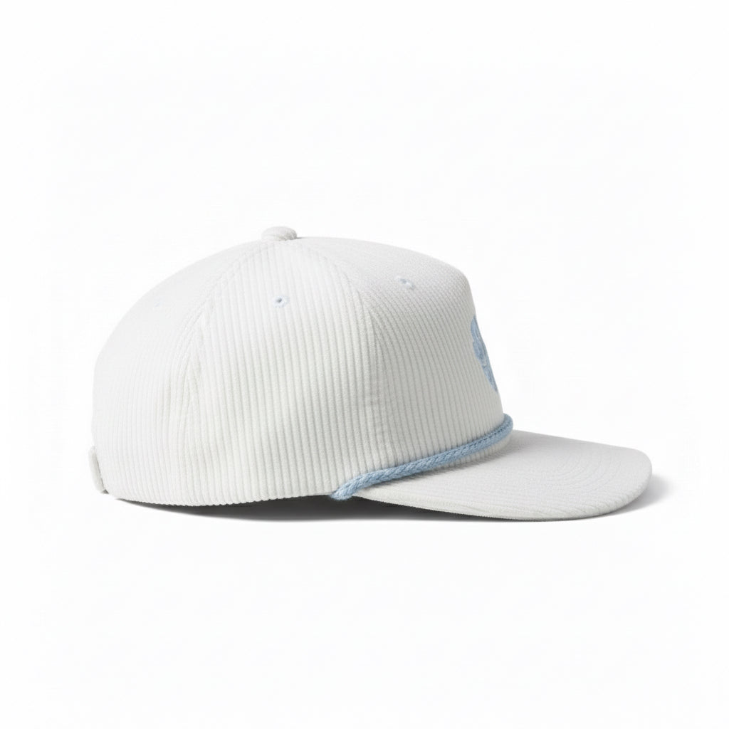 White corduroy cap with blue embroidery on a white background