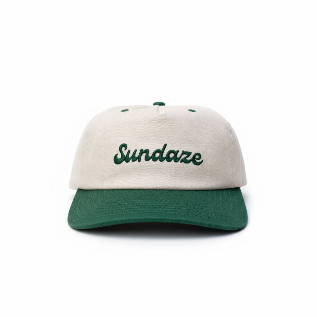 Cap with 'Sundaze' text on a rock in a forest setting