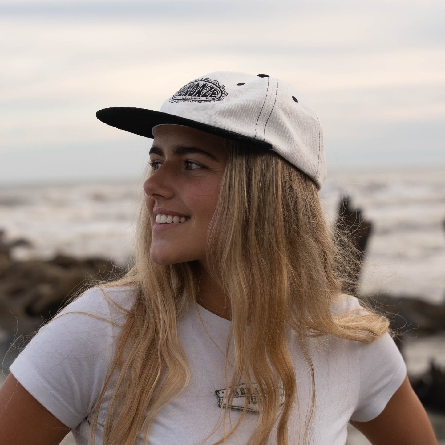 Surfer Girl wearing black and white corduroy hat from Sundaze