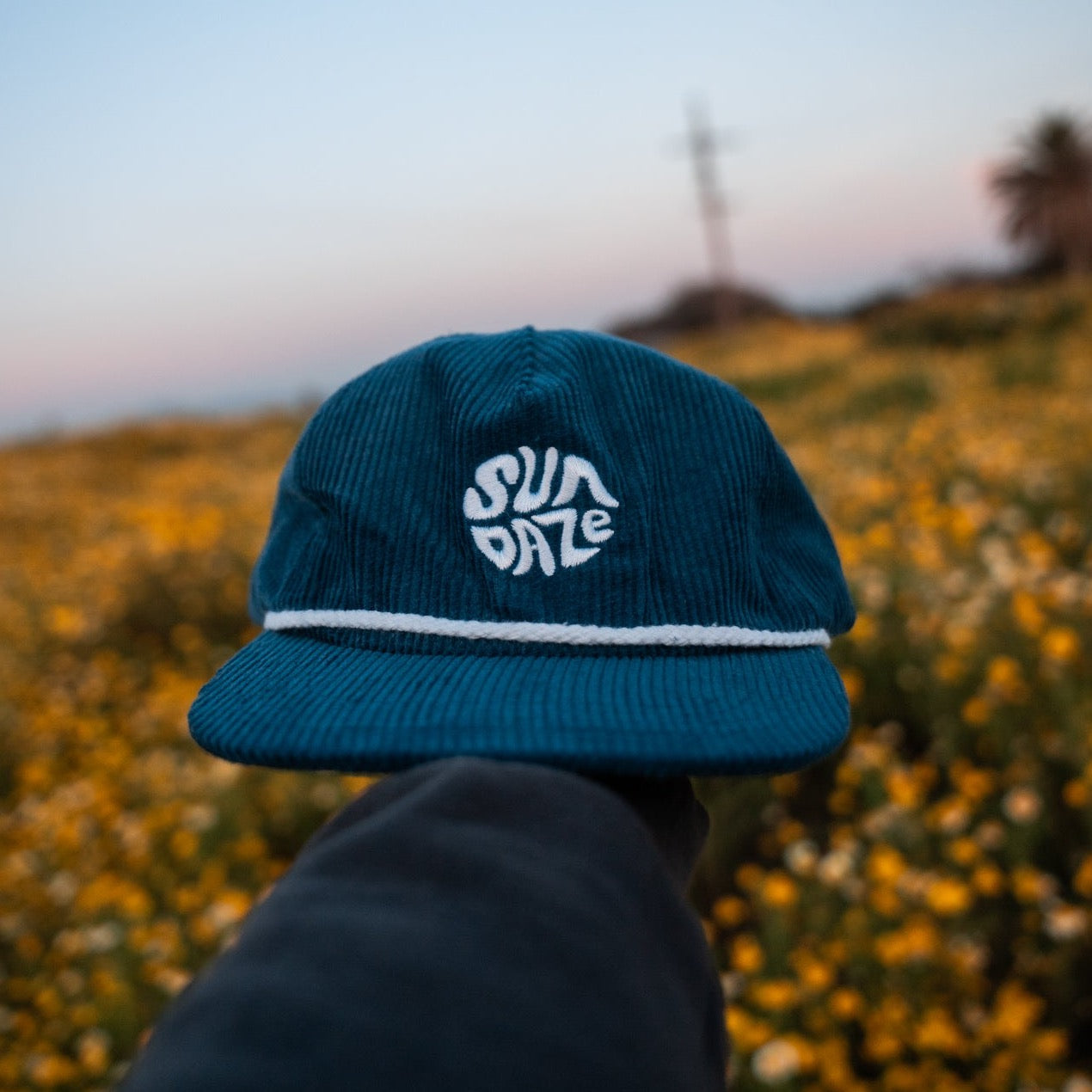 Dark Blue Corduroy Unstructured, low crown, corduroy, embroidered design, adjustable strap, 5-panel hat with a surf hat style, flat brim, and five-panel hat design.